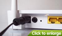 Connect the power supply to the mains and the back of the router. Switch the router on using the black button to the left of the power socket.